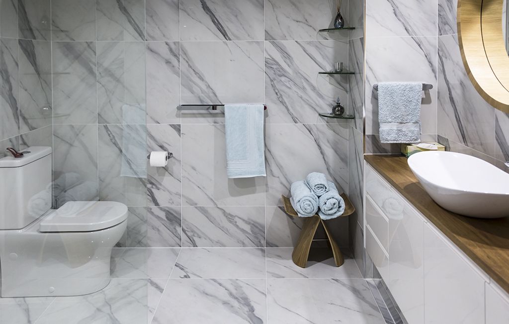 Marble tiled bathroom with chrome fittings.