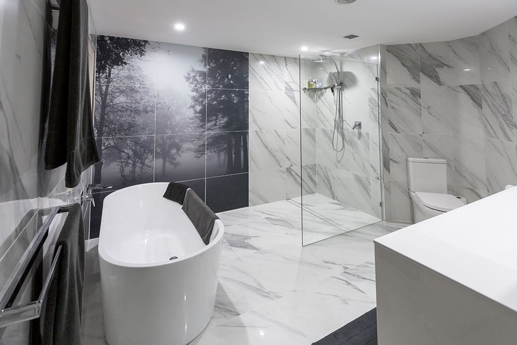 Marble tiled bathroom with chrome fittings.