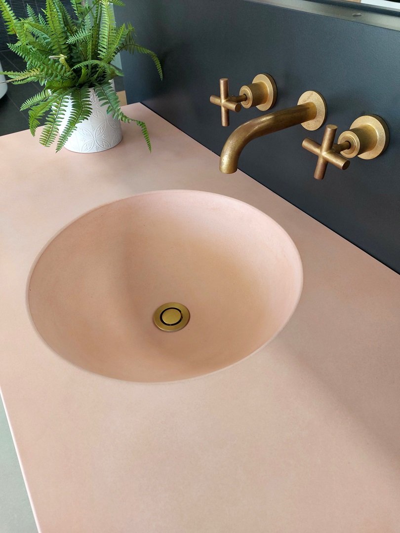 Concrete Studio Boya Quartz finish concrete vanity top & Astra Walker Icon wall set Urban Brass finish.