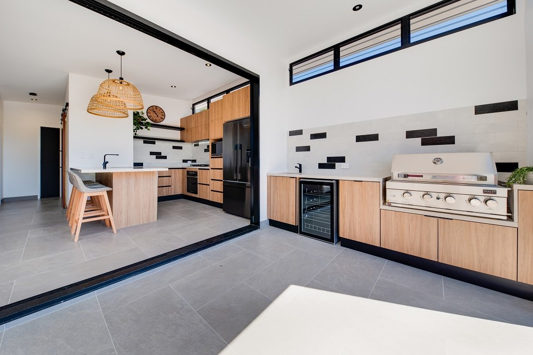 Open plan indoor/outdoor kitchen living on the Sunshine Coast - JT Homes Gossamer project.